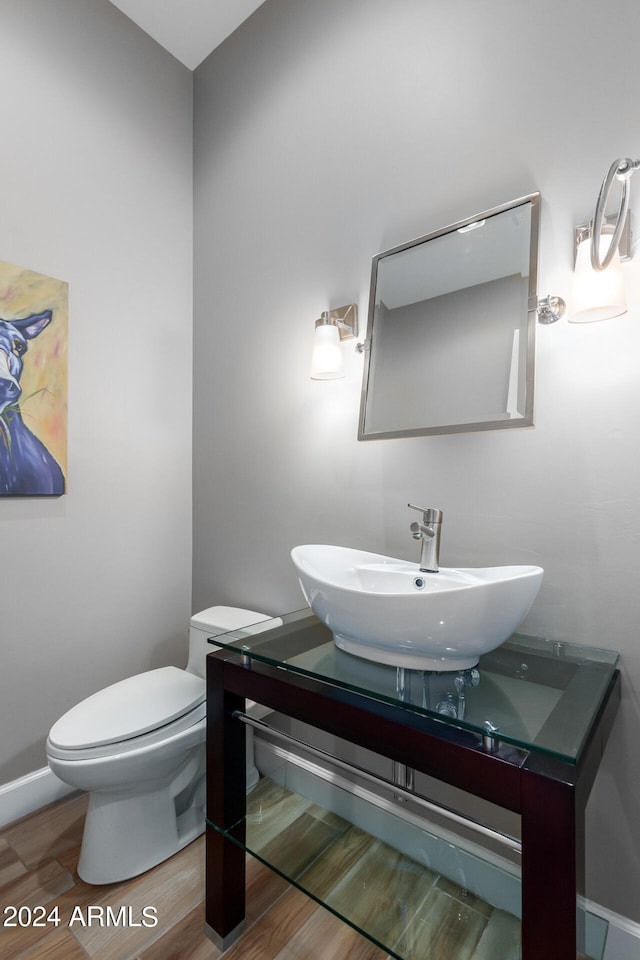 bathroom featuring vanity, toilet, and hardwood / wood-style flooring