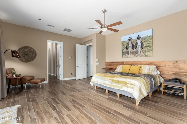 bedroom with wood-type flooring and ceiling fan