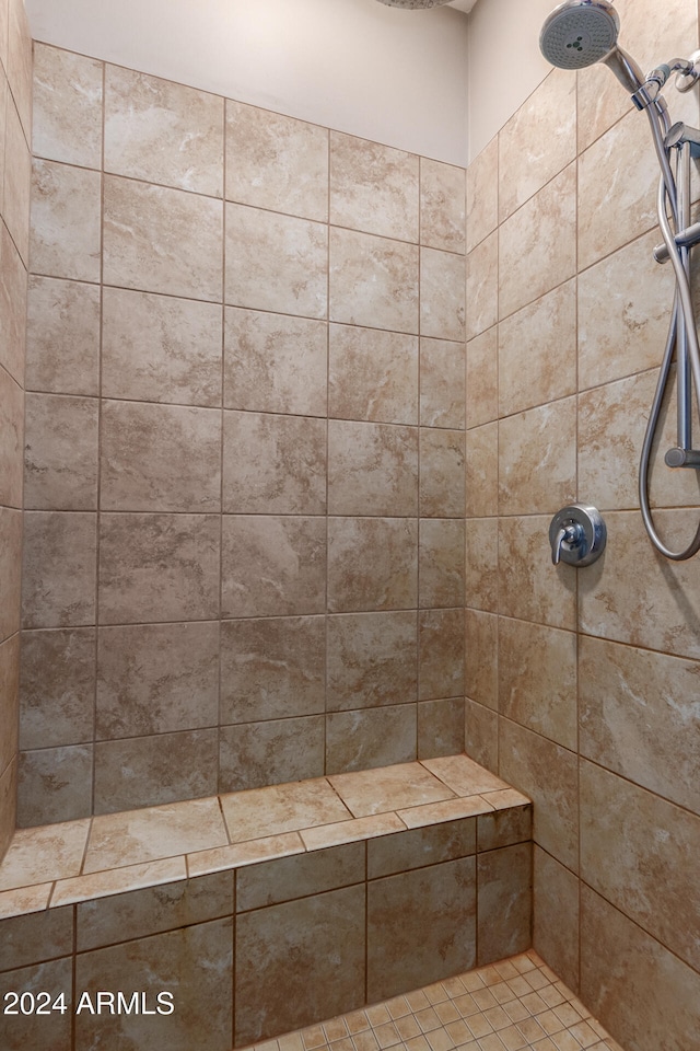 bathroom with a tile shower