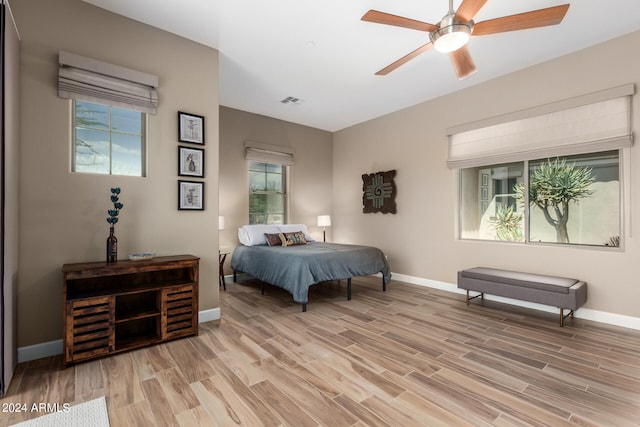 bedroom with light hardwood / wood-style flooring and ceiling fan