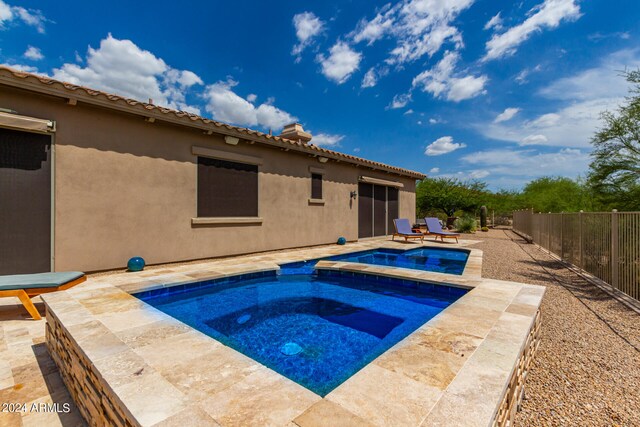 view of pool with an in ground hot tub and a patio area