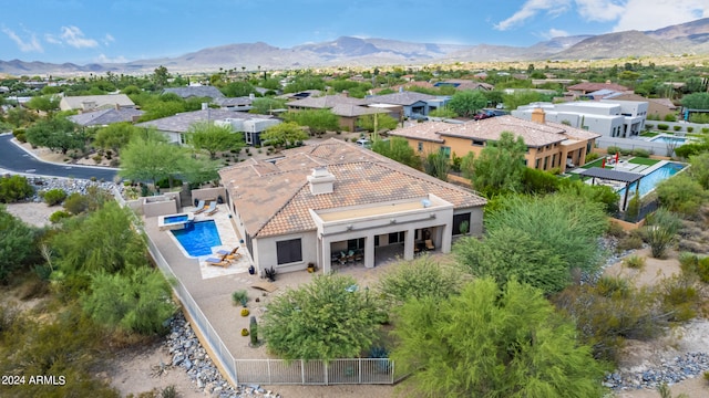 birds eye view of property with a mountain view