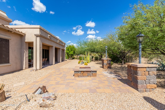 view of patio / terrace with an outdoor fire pit