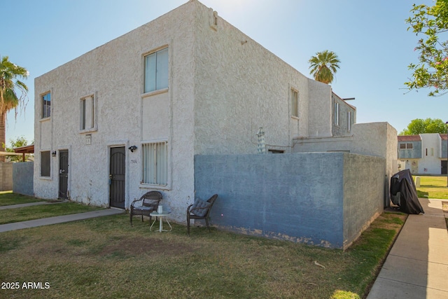 7506 N 47th Dr, Glendale, AZ 85301 - view of home's exterior with a yard and stucco siding
