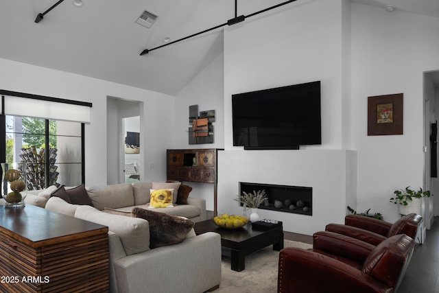 living room with high vaulted ceiling