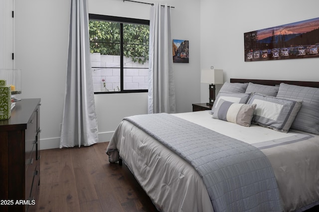 bedroom with dark wood-type flooring