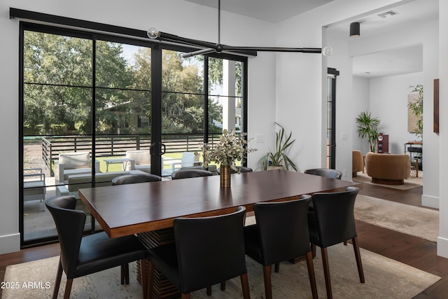 dining room with plenty of natural light and wood-type flooring