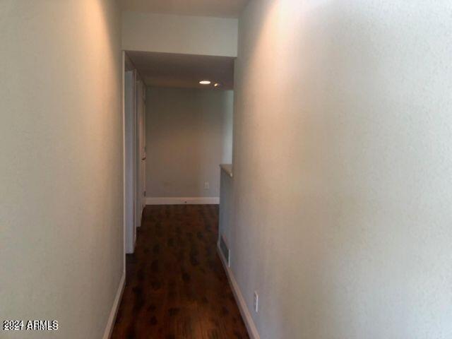 corridor featuring dark hardwood / wood-style flooring