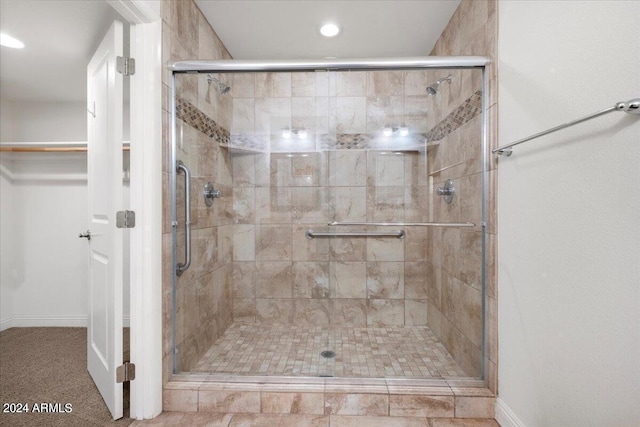 bathroom featuring a shower with shower door