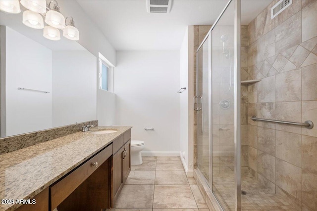 bathroom featuring a shower with door, toilet, tile patterned floors, and vanity