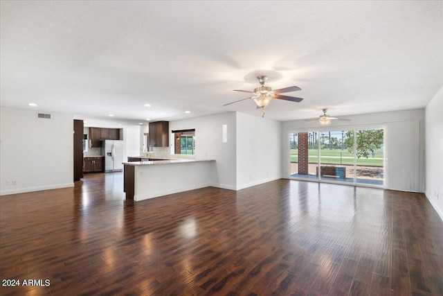 unfurnished living room with ceiling fan and dark hardwood / wood-style floors