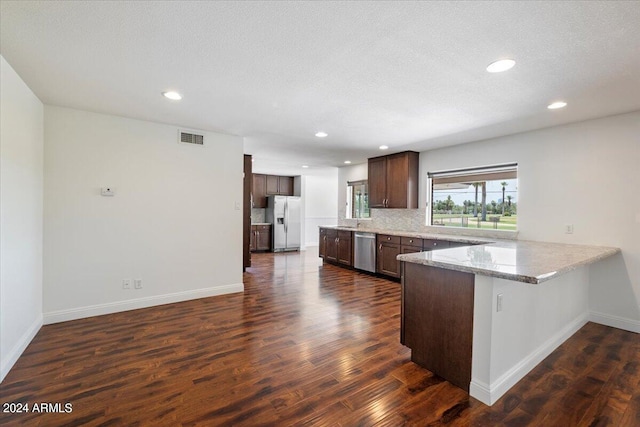 kitchen featuring dark hardwood / wood-style flooring, kitchen peninsula, refrigerator, and dishwasher