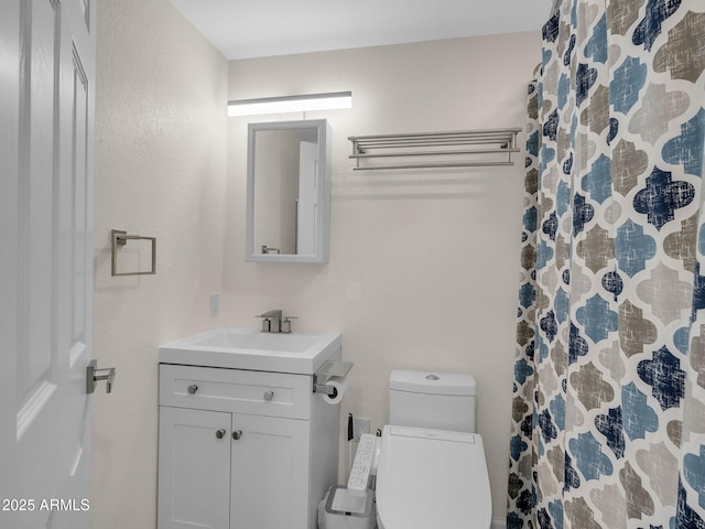 bathroom with toilet, curtained shower, and vanity