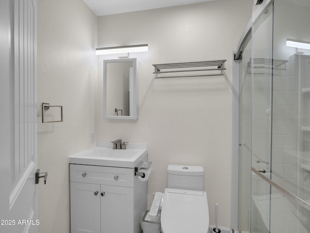 full bathroom with toilet, a shower stall, and vanity
