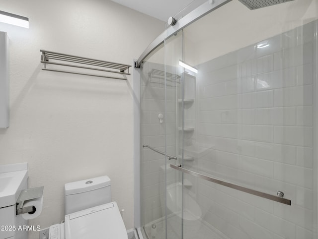 full bathroom with toilet, a shower stall, and vanity