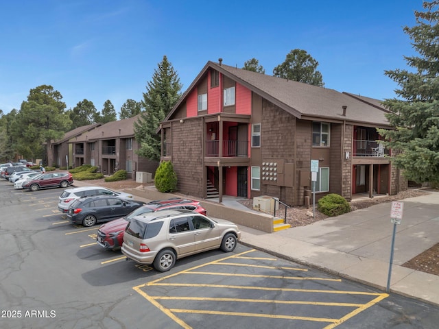view of property featuring uncovered parking