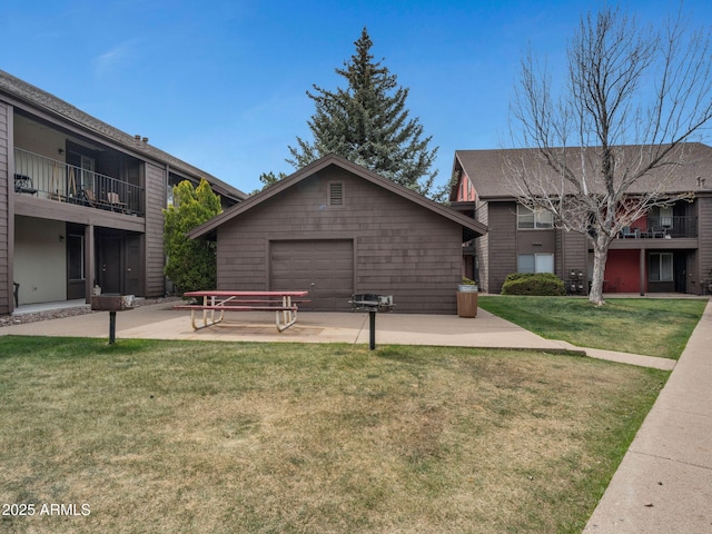 exterior space with a patio, a front yard, and a garage