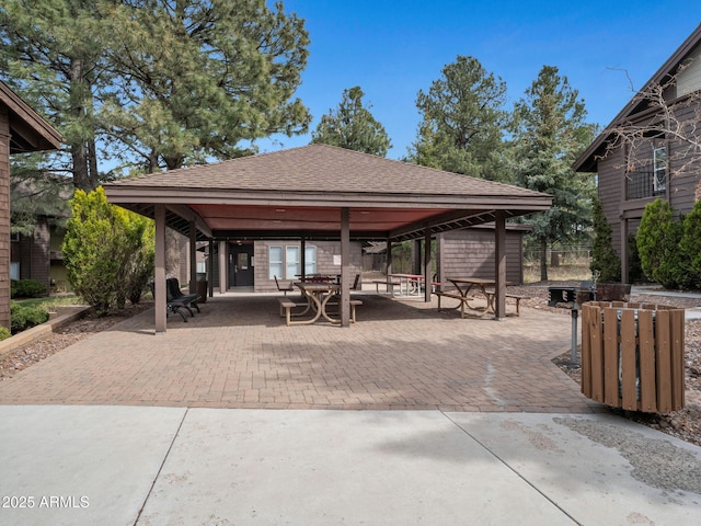 surrounding community featuring a patio, a gazebo, and outdoor dining area