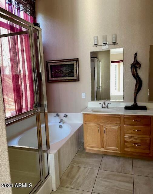 full bath with a bath, a shower stall, vanity, and tile patterned floors