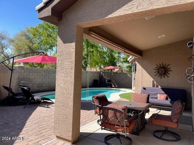 view of patio / terrace featuring a fenced in pool