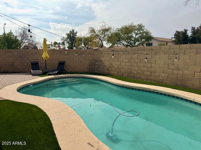 view of pool with a patio area, a fenced backyard, and a fenced in pool