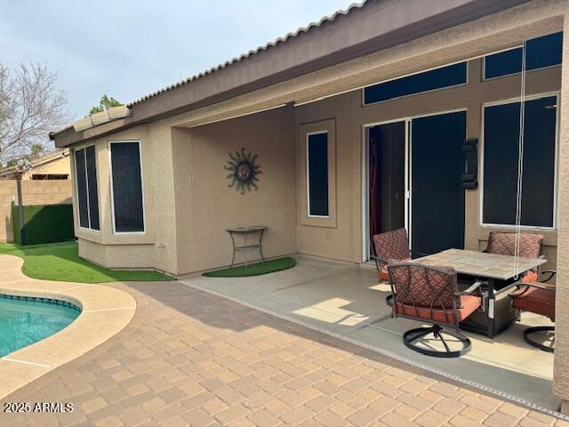 view of patio with fence and a fenced in pool