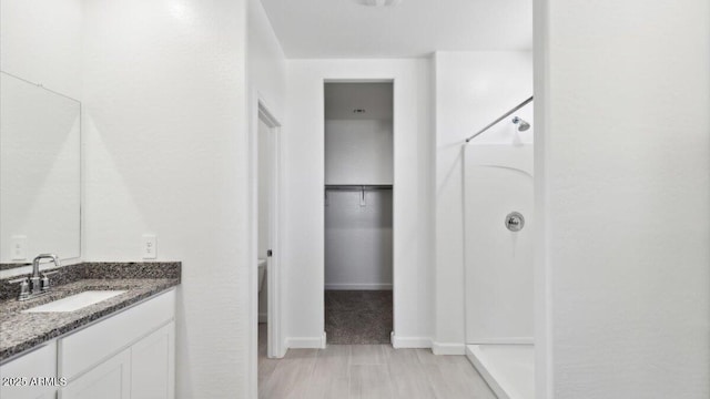 653 W Freedom St, Florence, AZ 85132 - full bathroom featuring a stall shower, vanity, and a walk in closet