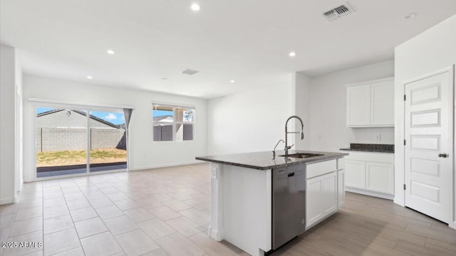 653 W Freedom St, Florence, AZ 85132 - kitchen featuring dishwasher, dark stone countertops, recessed lighting, white cabinets, and a center island with sink