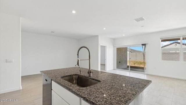 653 W Freedom St, Florence, AZ 85132 - kitchen featuring a kitchen island with sink, dark stone countertops, white cabinetry, dishwasher, and recessed lighting