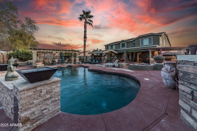 pool at dusk with a pergola, an outdoor bar, and a patio