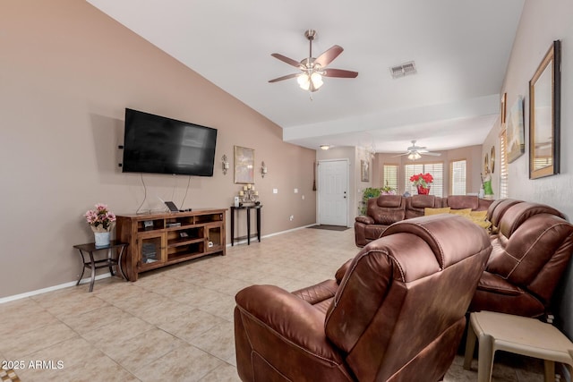 living area with ceiling fan, vaulted ceiling, baseboards, and light tile patterned floors