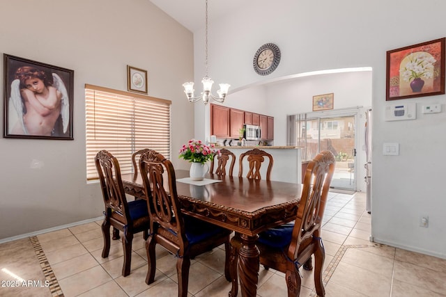 dining room featuring high vaulted ceiling, a chandelier, light tile patterned floors, and baseboards
