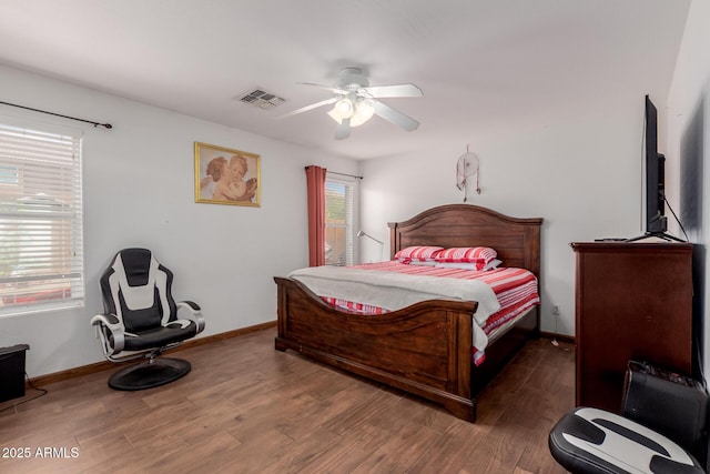 bedroom featuring wood finished floors, baseboards, and a ceiling fan