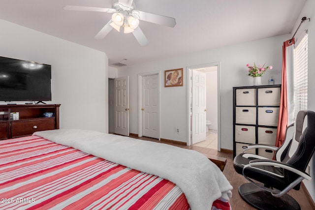 bedroom featuring connected bathroom, a ceiling fan, and wood finished floors