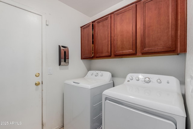 laundry room with separate washer and dryer and cabinet space