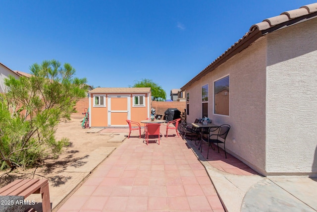 fenced backyard with a patio, a grill, and outdoor dining area