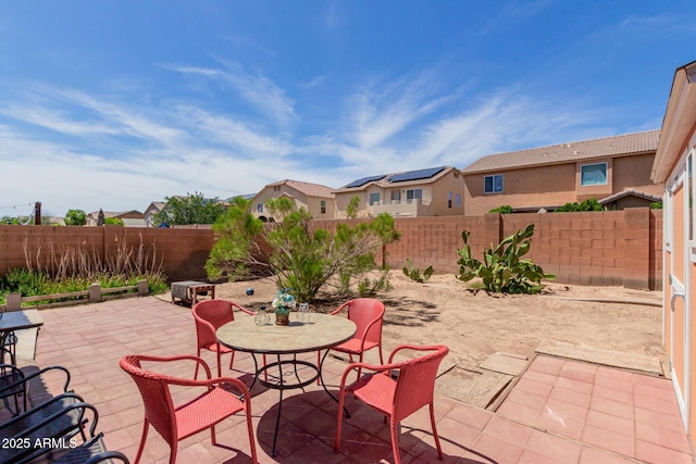 fenced backyard featuring a patio, a residential view, and outdoor dining area