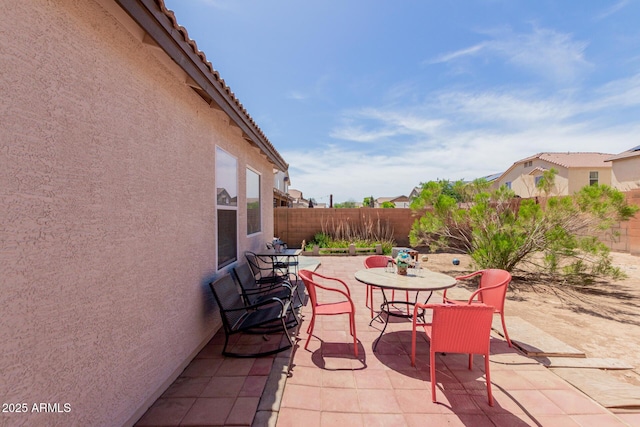 fenced backyard featuring a patio area and outdoor dining area