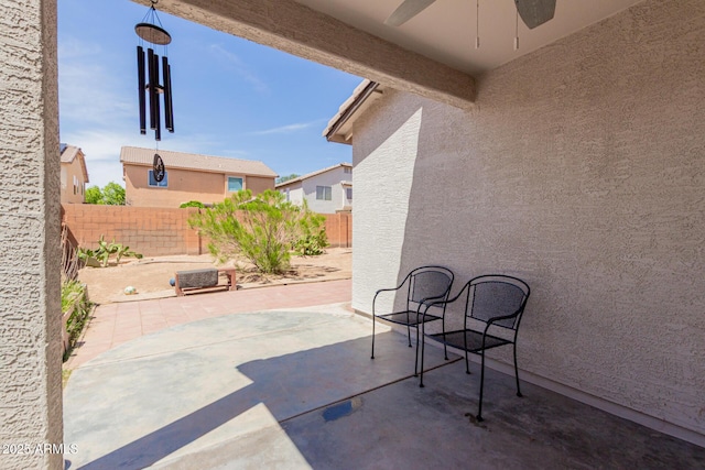fenced backyard with ceiling fan and a patio area