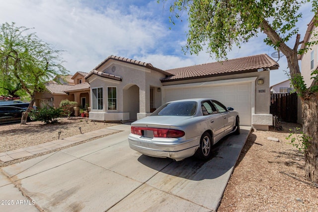 mediterranean / spanish-style house featuring concrete driveway, stucco siding, and an attached garage