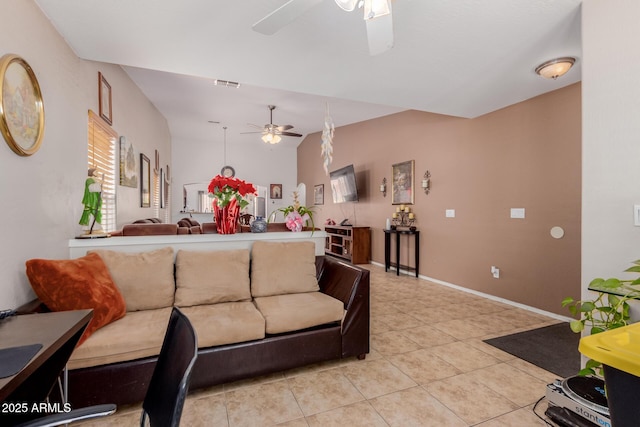 living room with ceiling fan, light tile patterned floors, and baseboards