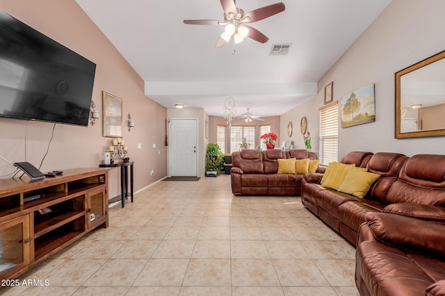 living area featuring ceiling fan, lofted ceiling, and light tile patterned floors