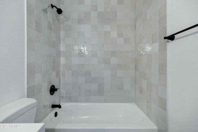 bathroom with bathing tub / shower combination and toilet