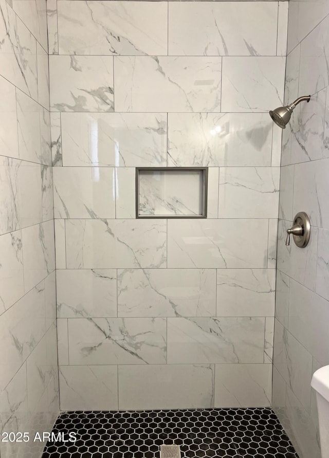 bathroom with a tile shower