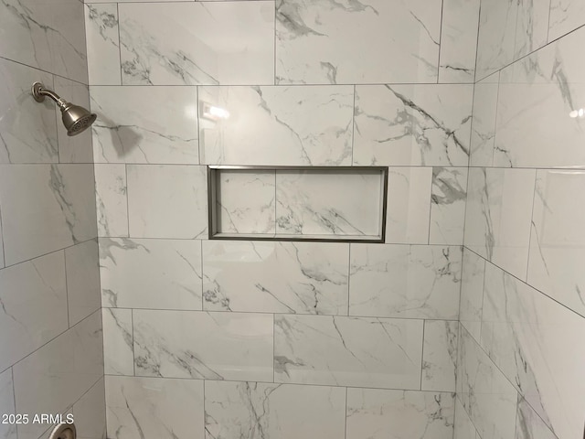 interior details with a tile shower