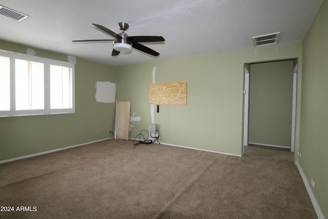 carpeted empty room with ceiling fan