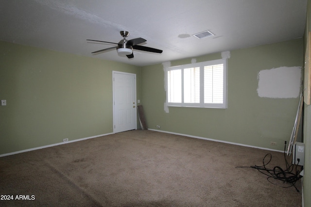 carpeted spare room with ceiling fan