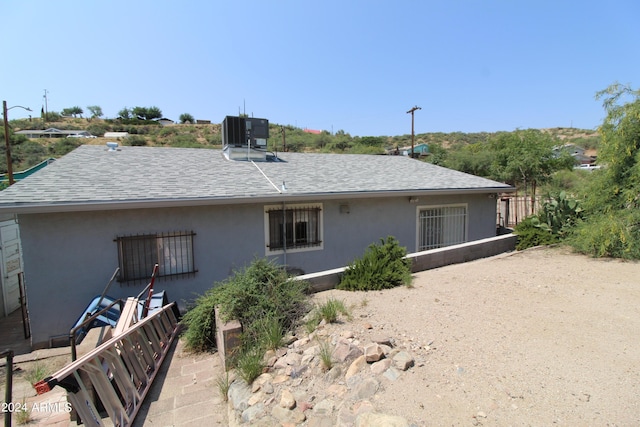 back of property featuring cooling unit