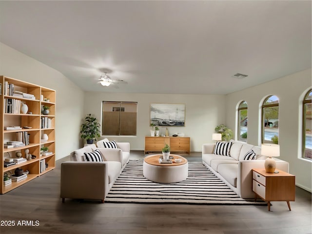 living area with ceiling fan, visible vents, and wood finished floors