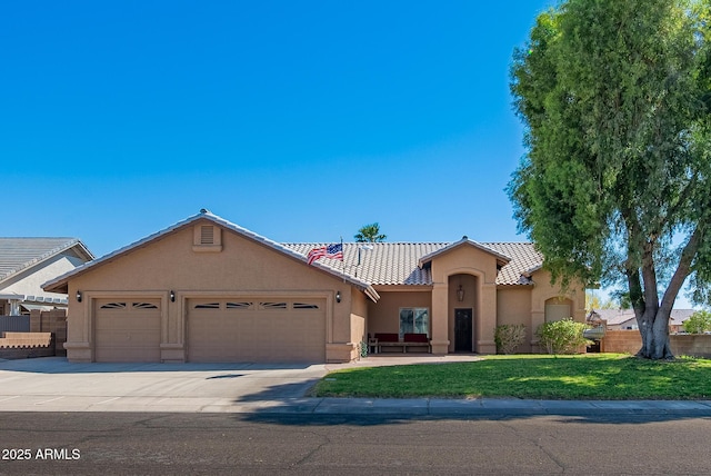 10691 E 37th Pl, Yuma, AZ 85365 - mediterranean / spanish house featuring concrete driveway, stucco siding, an attached garage, a tiled roof, and fence